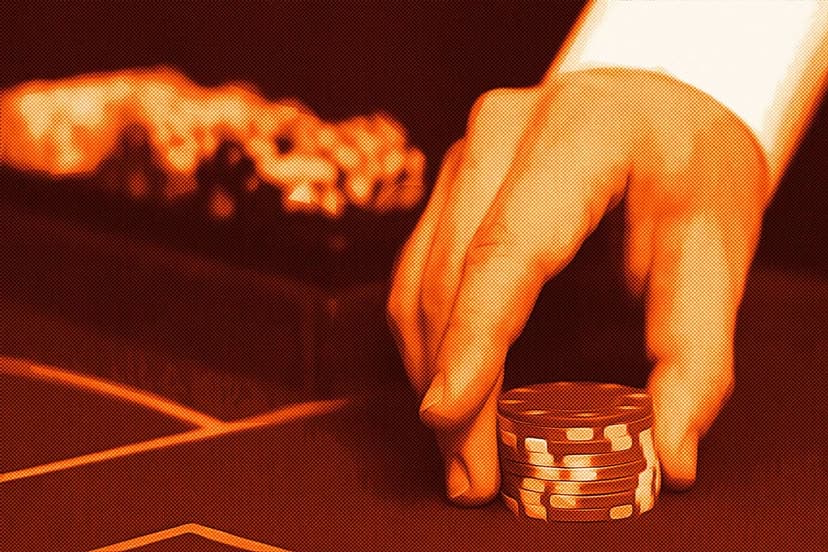 Casino dealer hand holding chips